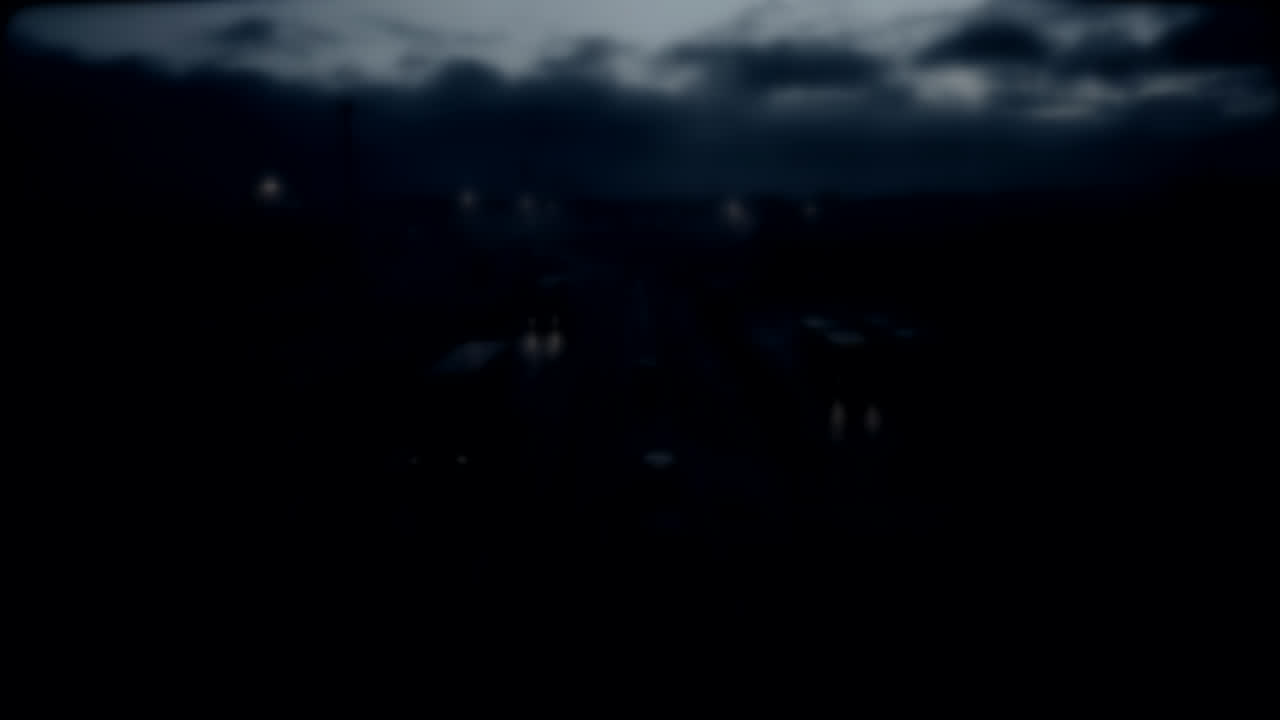 Aerial reconnaissance view descending toward a coastal industrial area at dusk